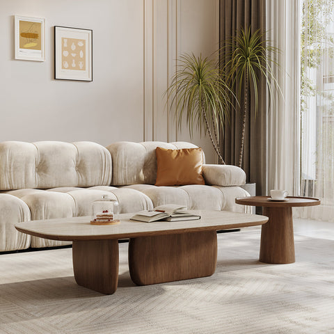 Modern oval barakat travertine coffee table set with light wood top and dark brown sculpted base in walnut finish