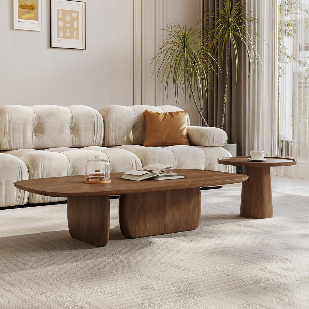 Modern walnut barakat travertine coffee table set with oval top and sculpted organic legs for stylish living rooms
