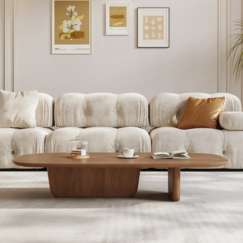 A sleek oval walnut barakat travertine coffee table with minimalist design and two sturdy legs in a coffee table set