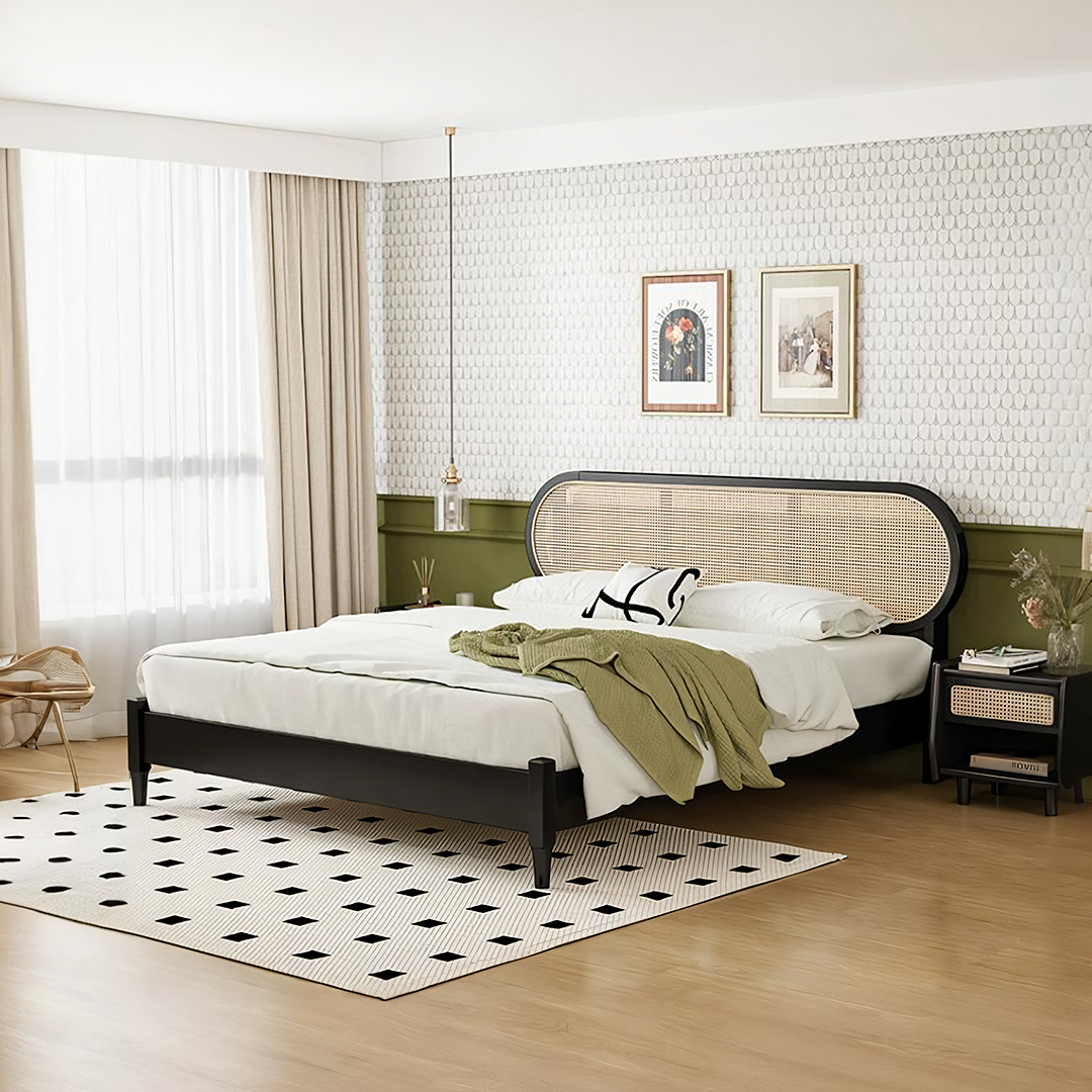 Black-framed barbara queen size bed with woven cane headboard and nightstand dressed in white linens and olive throw
