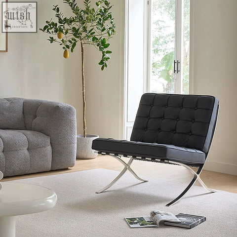 Black leather barcelona chair with real leather upholstery and sleek painted steel x-frame base for stylish seating