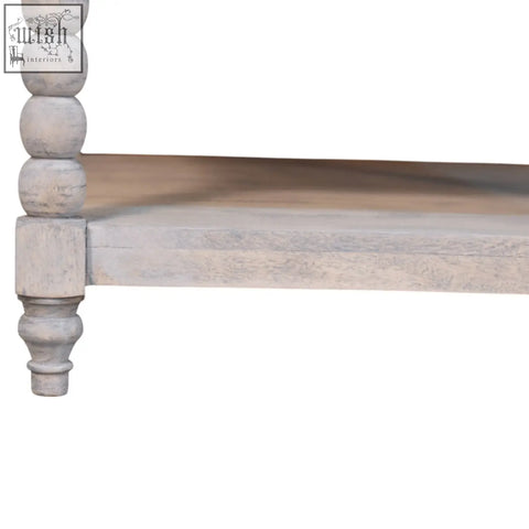 A rustic white wooden lower shelf with turned bead detailing on the barclay acid wash coffee table leg