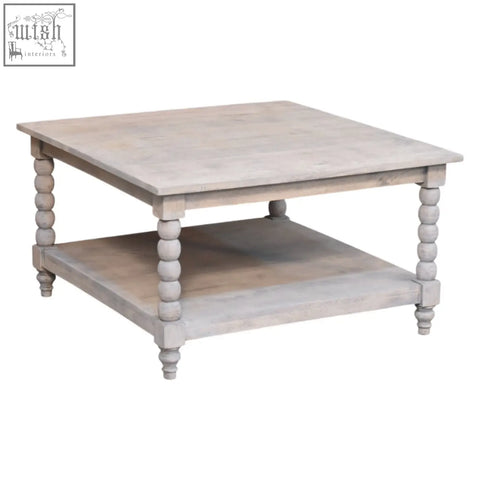 Barclay acid wash coffee table with distressed white finish, turned wooden legs, and open lower shelf for storage