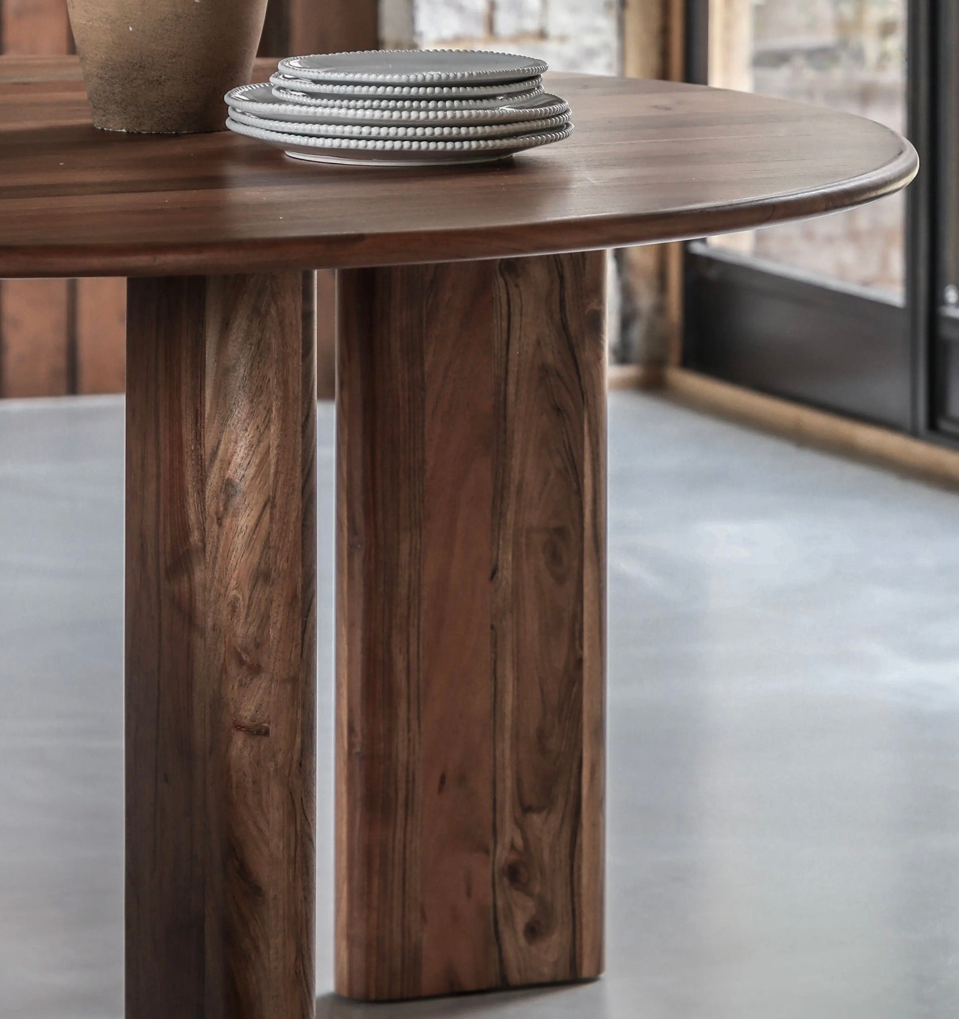 Stack of gray ceramic plates with textured beaded rim for bardo round dining round dining table setup