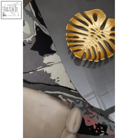 Golden monstera leaf-shaped decorative tray paired with a mink velvet scalloped dining chair for stylish dining