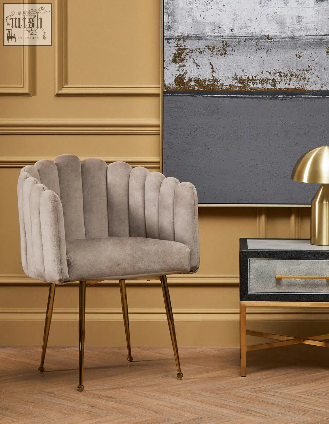 A sleek light gray mink velvet scalloped dining chair with gold-tone metal legs perfect for stylish dining rooms