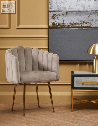 A sleek light gray mink velvet scalloped dining chair with gold-tone metal legs perfect for stylish dining rooms