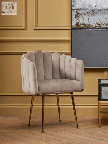 A sleek light gray mink velvet scalloped dining chair with gold-toned metal legs perfect for stylish dining rooms