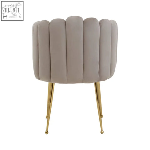 A taupe mink velvet scalloped dining chair with fluted back and slender gold-tone legs perfect for dining rooms