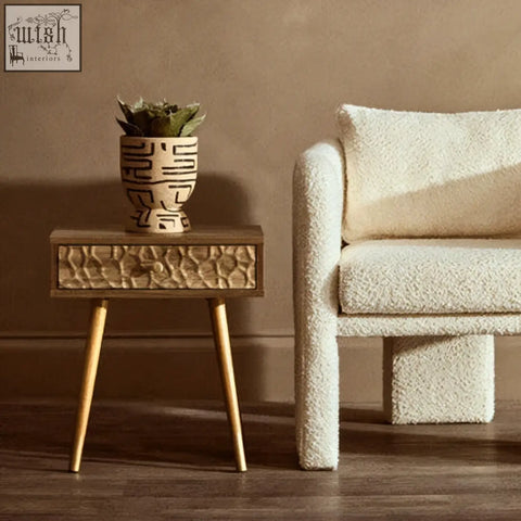 Small rectangular side table with textured wooden top and light golden legs paired with hand painted earthenware planter
