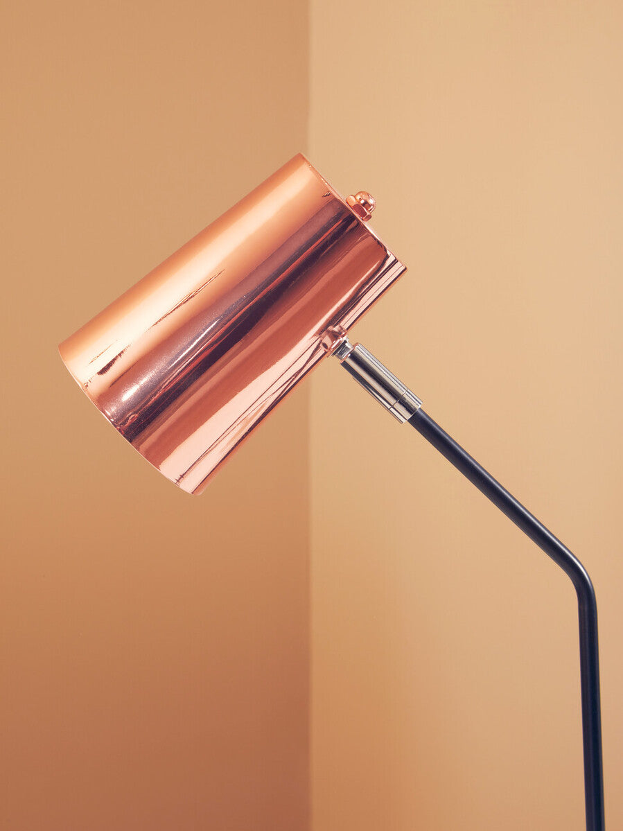 Sleek copper desk lamp with cylindrical copper finish and black articulated arm perfect for stylish desk use