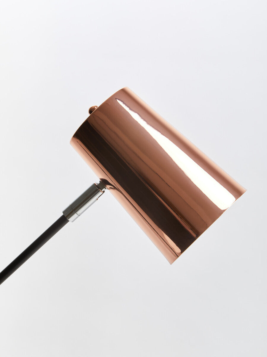 Bart copper desk lamp is a sleek copper desk lamp with a cylindrical finish and a minimalist design with black cord