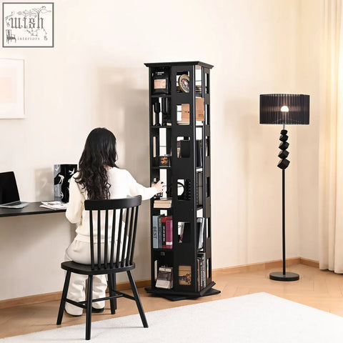 Black solid wood bartholomew rotating bookshelf with glass panels displaying books and decor on multiple shelves