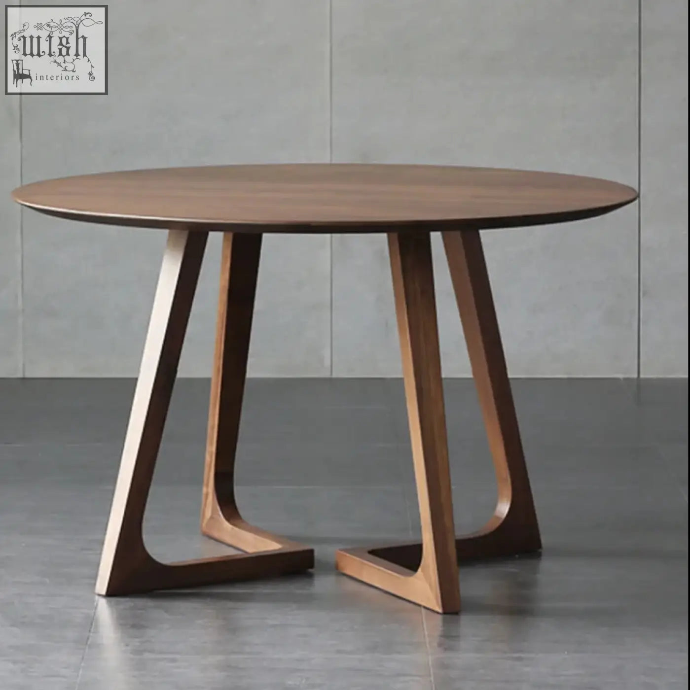 Modern round bashira dining table with warm brown wood finish and sleek angular legs perfect for dining table setups