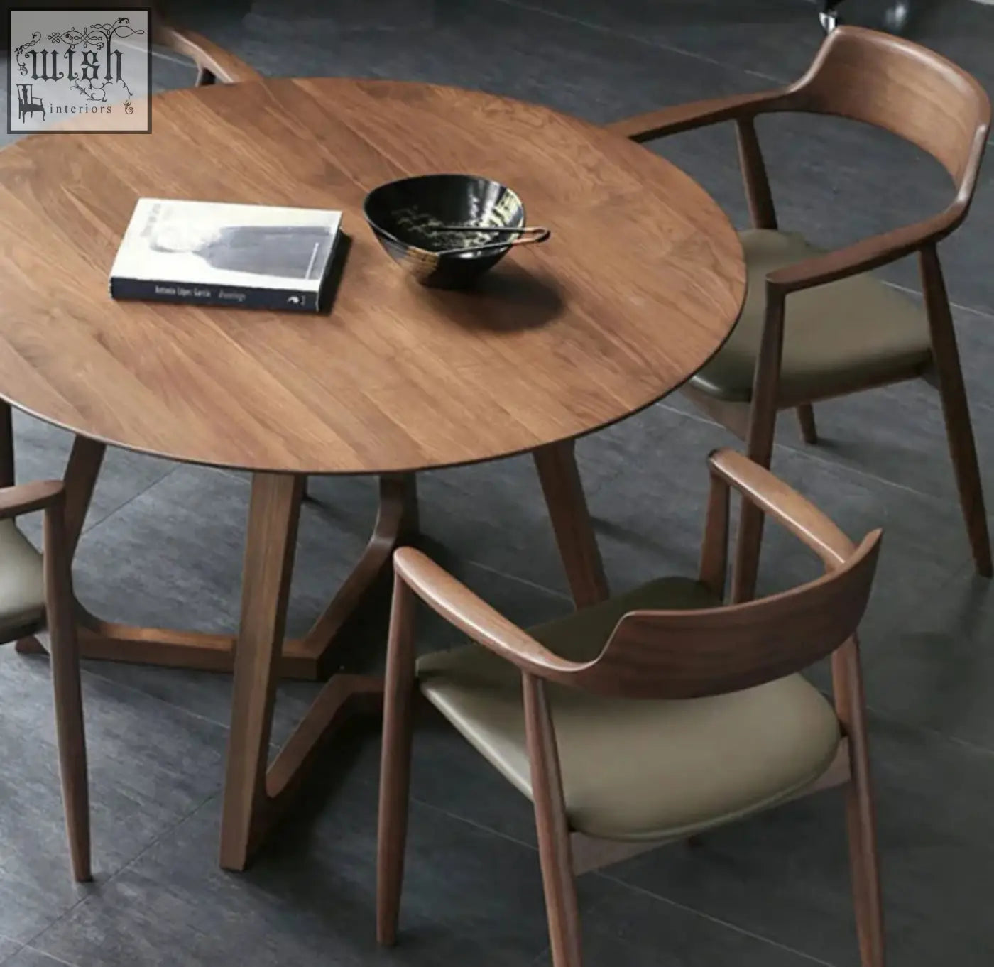 Round wooden bashira dining table with warm natural finish and sleek tapered legs for stylish dining spaces