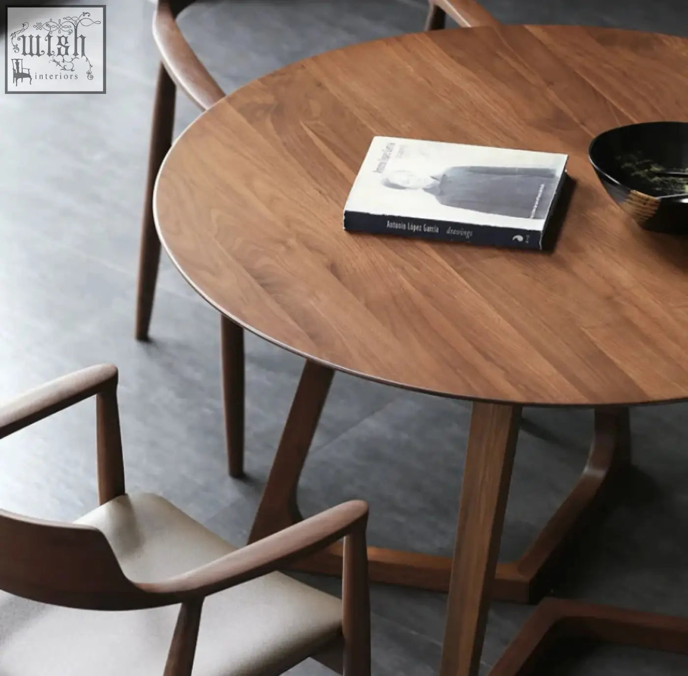 Round wooden bashira dining table with warm natural finish and sleek tapered legs for stylish dining bashira dining