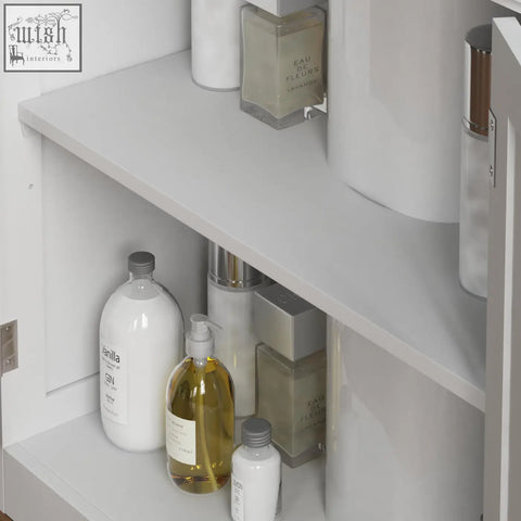 White ceramic bottle with gray cap labeled vanilla on shelf inside bath vida priano bathroom storage cupboard