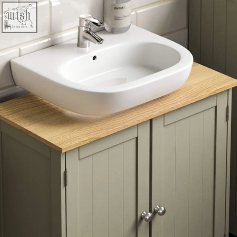 White ceramic basin with modern design on light oak countertop in grey and oak bath vida priano cabinet unit