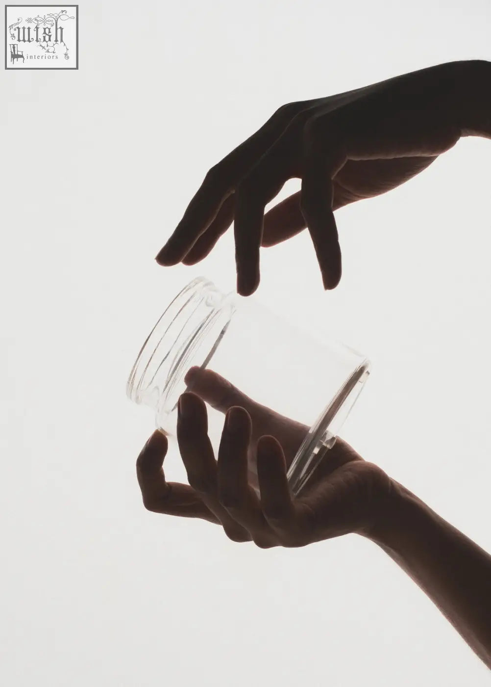 Transparent glass storage jar with ridged rim and smooth sides perfect for cotton pads in bathroom use