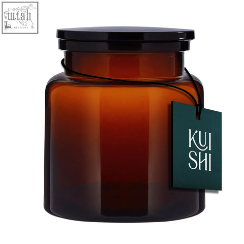 A sleek amber glass bathroom storage jar with black lid and kui shi tag perfect for cotton pads storage