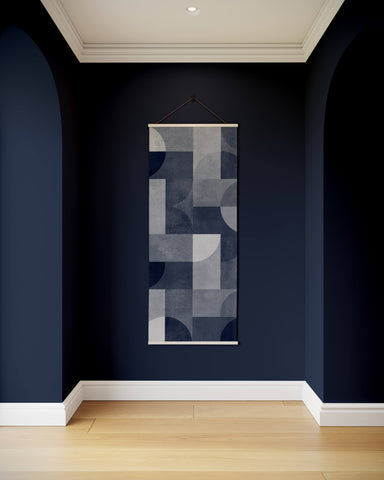 A bauhaus geometric concrete effect tapestry with overlapping gray and navy shapes framed by a thin wooden border