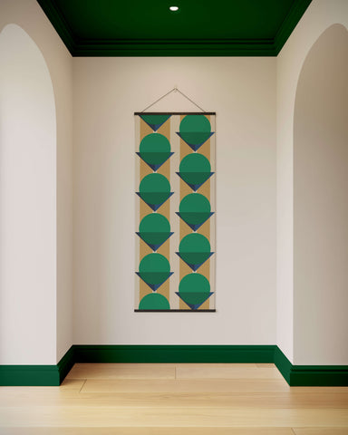 A bauhaus geometric tapestry with teal and navy circular shapes on beige background framed by dark green borders