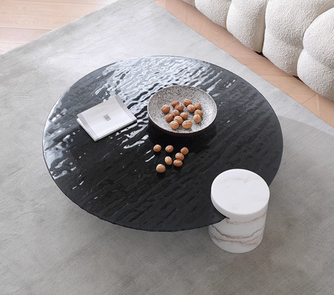 Black circular baxter coffee table with textured hammered metal wave top surface perfect for stylish living rooms