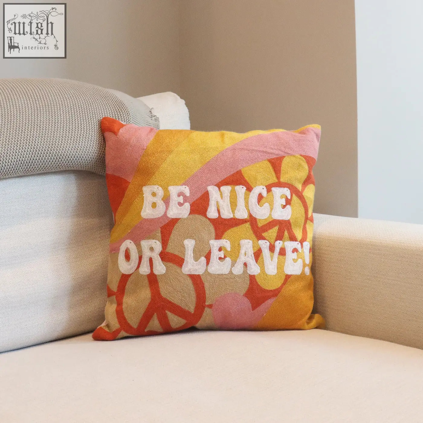 Be nice or leave needlepoint cushion with vibrant orange and yellow peace signs on textured fabric base needlepoint cushion