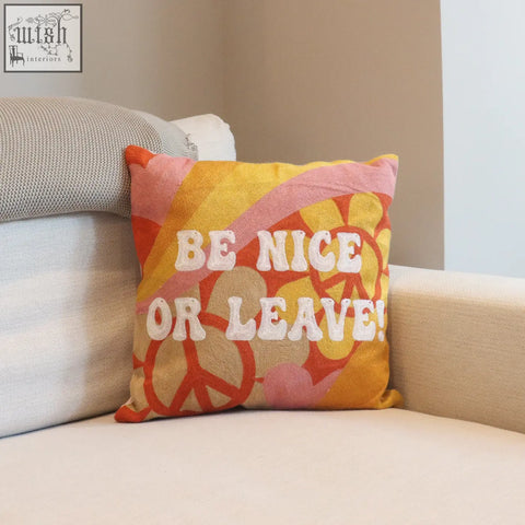 Be nice or leave needlepoint cushion with vibrant orange and yellow peace signs on textured fabric base needlepoint cushion