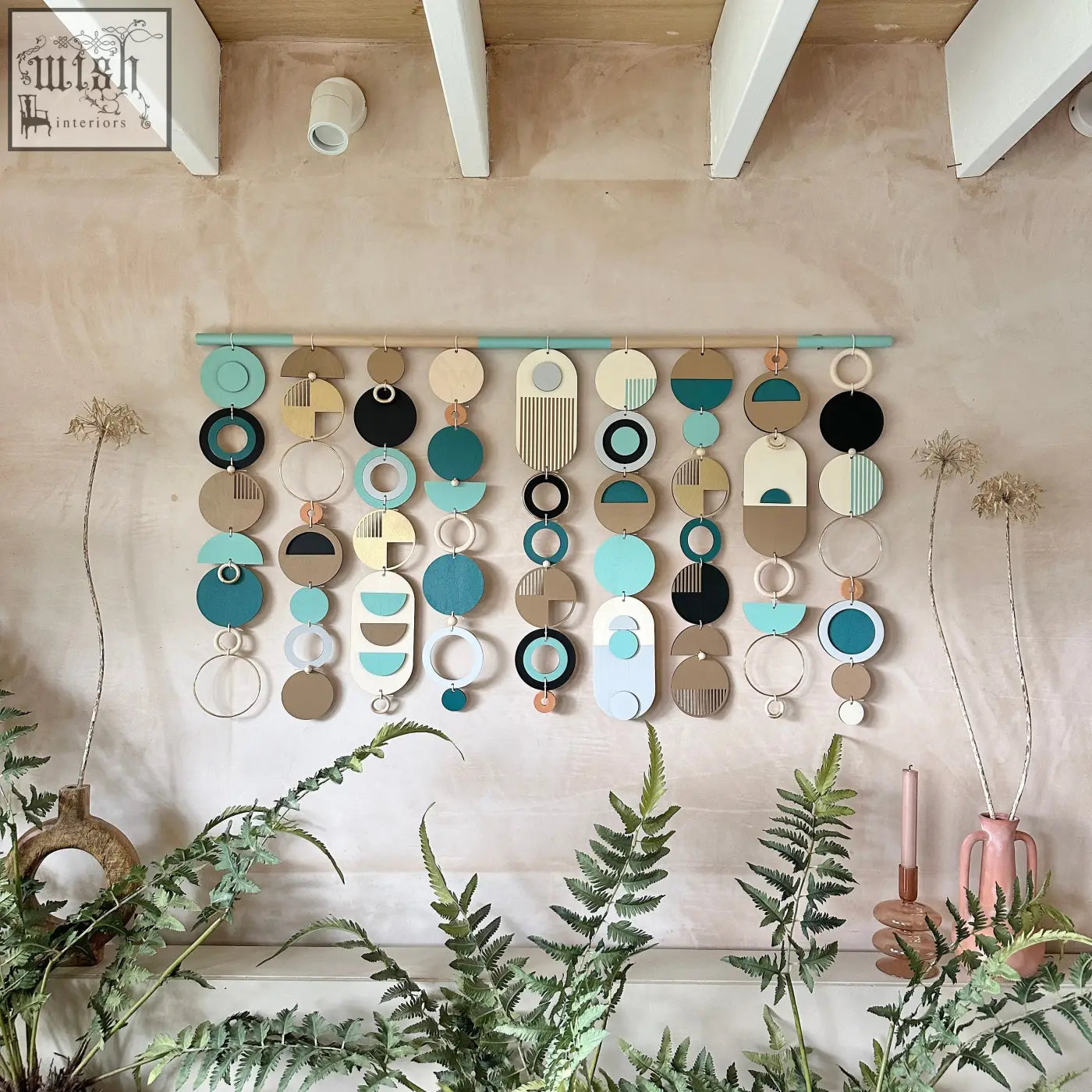 A modern wall art wooden geometric artwork with teal black beige and white discs perfect for minimalist decor