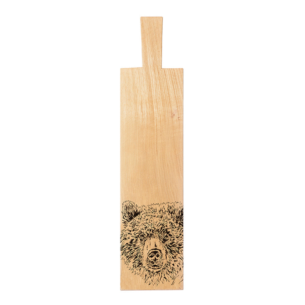 Light-colored wooden bear oak paddle long cutting board with hand-carved bear face design at the bottom