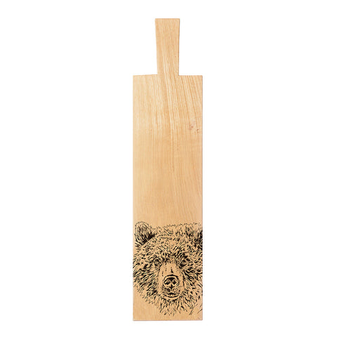 Light-colored wooden bear oak paddle long cutting board with hand-carved bear face design at the bottom