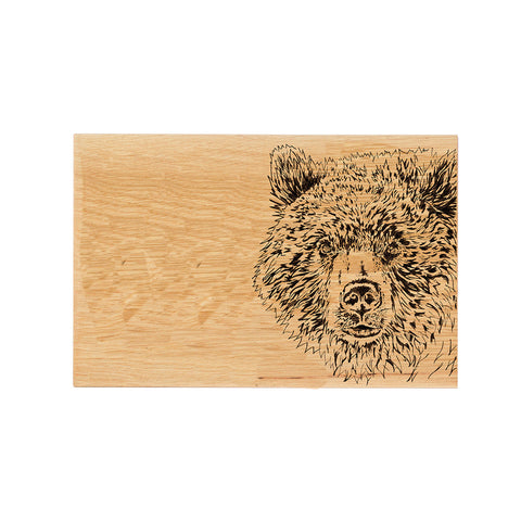 A light brown oak serving board with a detailed black burned bear oak illustration perfect for cheese and snacks