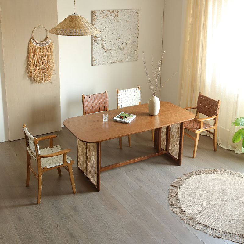 A light brown ash wood dining chair with woven cane panels and a smooth rounded top without armrest