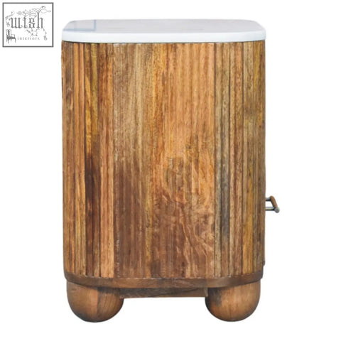 A rustic beaumont marble bedside table with a white marble top and solid mango wood rounded ball feet
