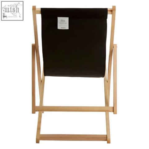Black deck chair with light wood frame and black canvas seat perfect for relaxing on your deck or patio