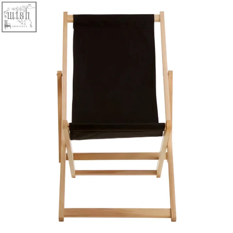 Black deck chair with light wood frame and black canvas seat perfect for relaxing on your deck or patio