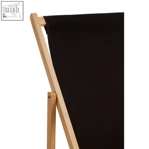 Black canvas draped over a light wood easel showcasing the fabric of the Beauport black deck chair
