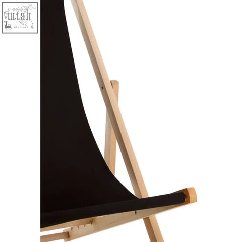 Black canvas deck chair with light wood frame perfect for relaxing on your black deck or patio
