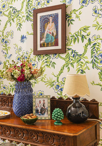 Blue textured ceramic vase holding colorful flowers next to beautifully sweet scallop lampshade product display