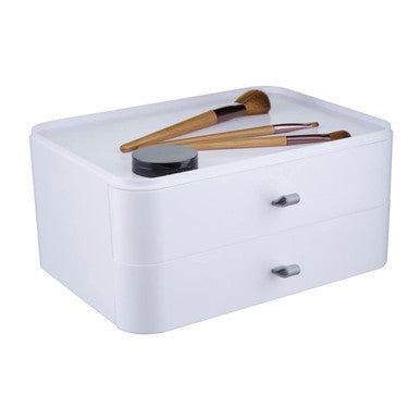 White two-drawer cosmetics organiser with silver handles and wooden-handled makeup brushes on top