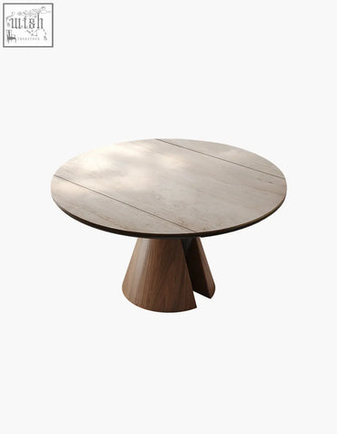 Modern round dining table with light gray stone top and dark wood geometric legs perfect for round dining spaces