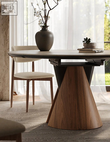 A sleek becerra foldable round dining table with a light gray stone top and wooden conical base perfect for round dining