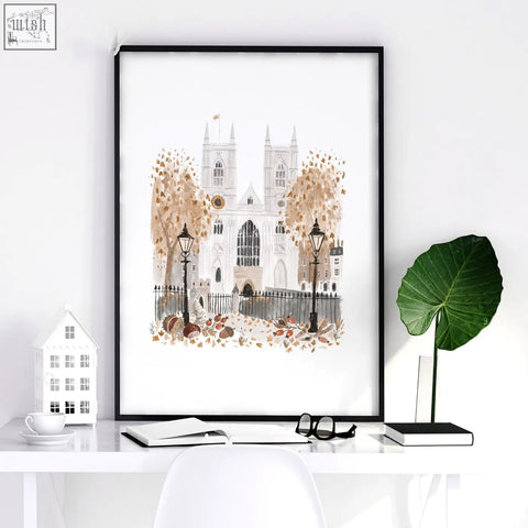 Black-framed bedroom framed picture of a cathedral with autumn trees and lampposts from wintertime in london set