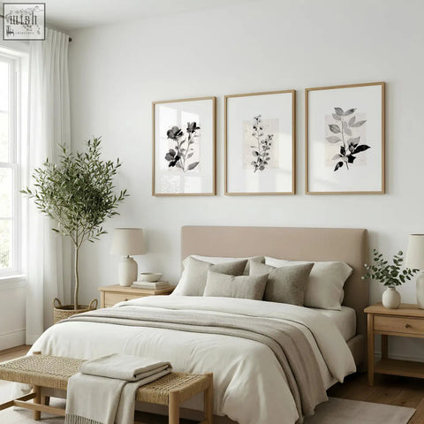Beige upholstered bed with matching pillows and throw blanket paired with rustic botanical french country wall art prints