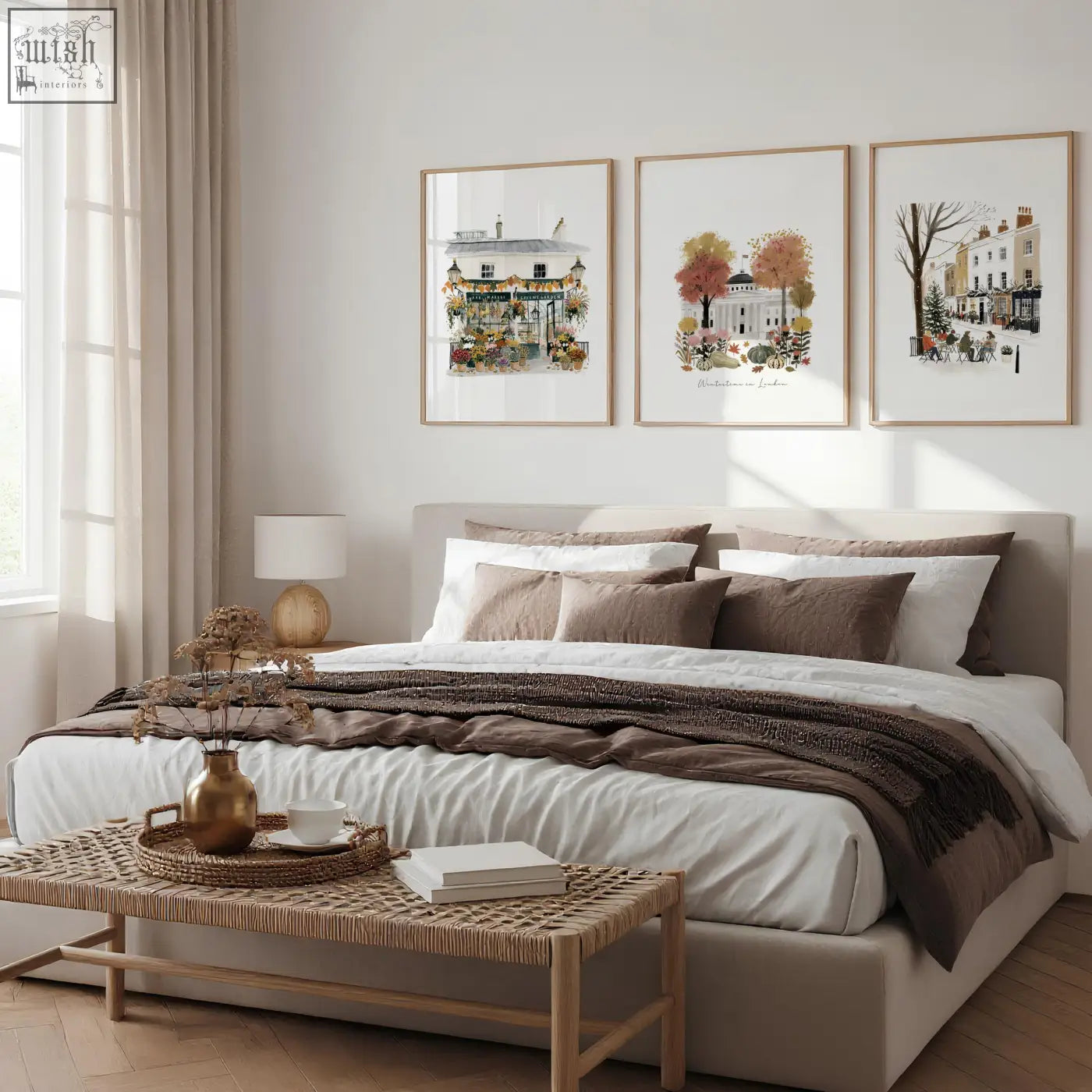 Beige upholstered bed with white linens and brown pillows below london travel art bedroom wall frames set of 3
