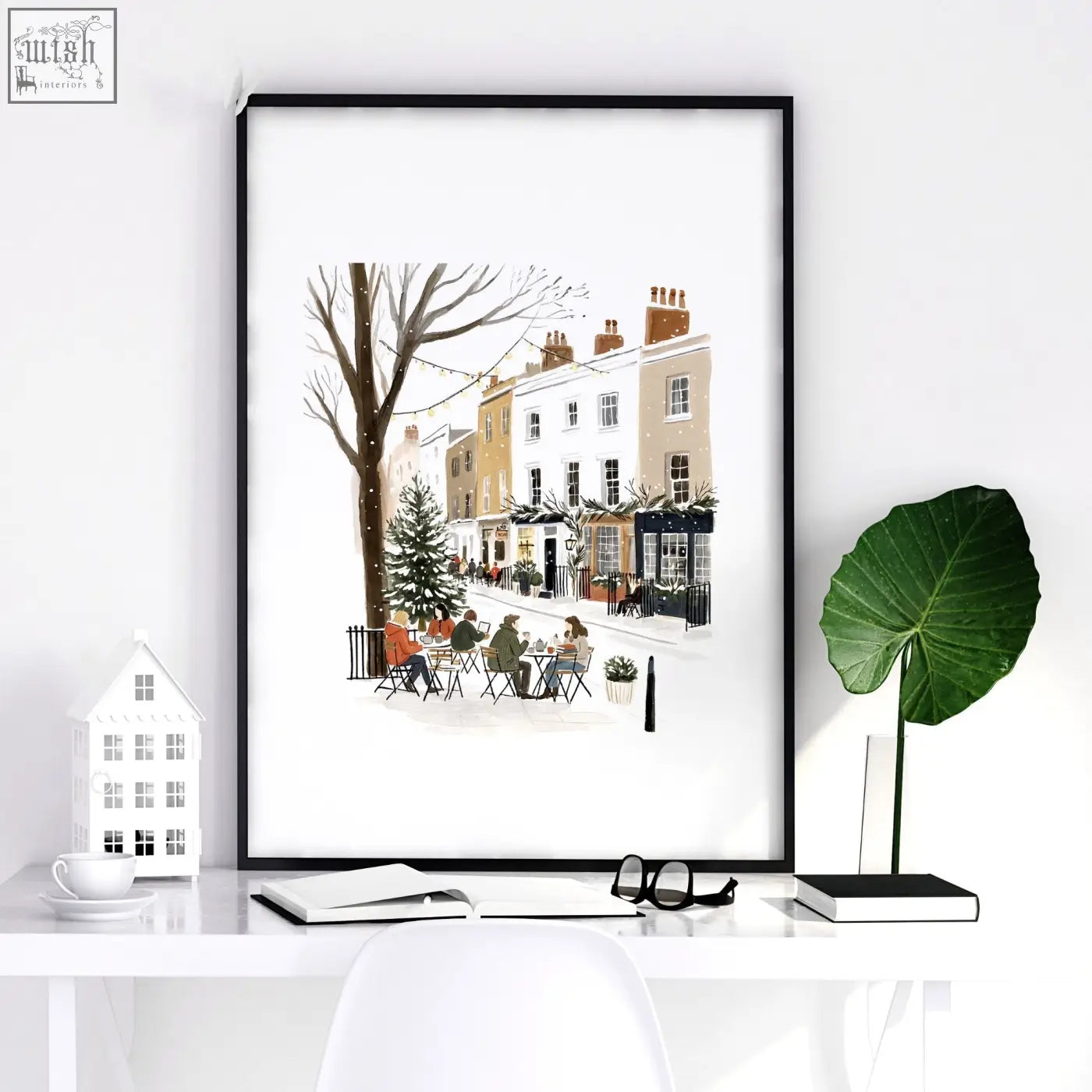 Black-framed bedroom wall frames with a snowy london street scene and outdoor tables for cozy bedroom wall decor