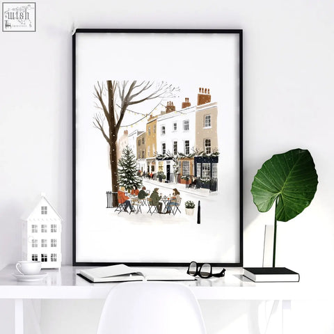 Black-framed bedroom wall frames with a snowy london street scene and outdoor tables for cozy bedroom wall decor
