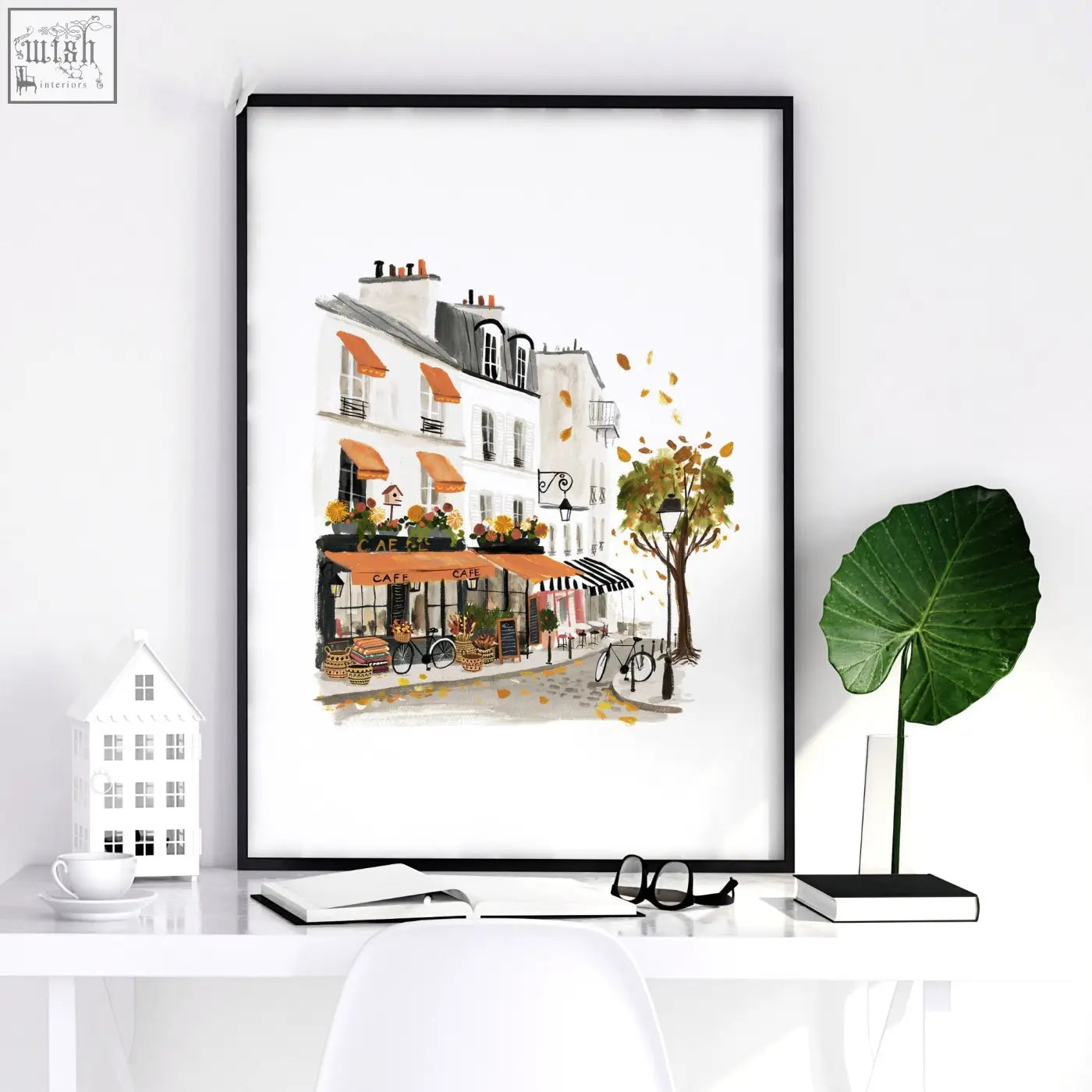 Black-framed bedroom wall picture of parisian street scene with orange awnings and autumn leaves in watercolor style