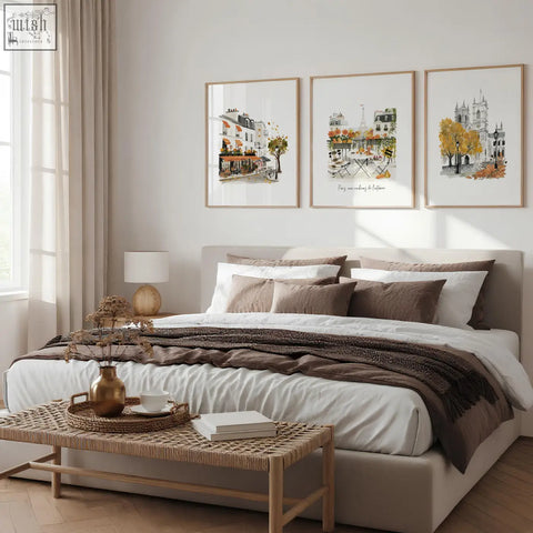 Beige upholstered bed with white linens and brown pillows paired with bedroom wall pictures parisian autumn travel art set of 3
